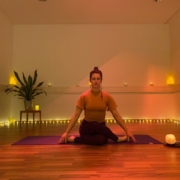 yoga teacher in yoga studio. Candlelight.